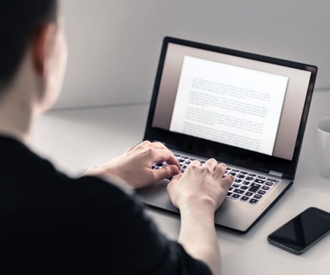 Man Writing With Laptop — Document Management in Australia