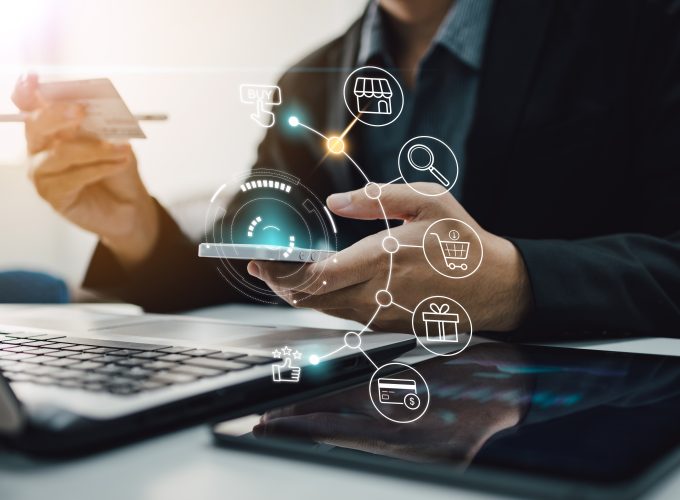 Businessman with mobile smartphone in hand paying online and shopping on virtual interface global network, online banking and digital marketing.